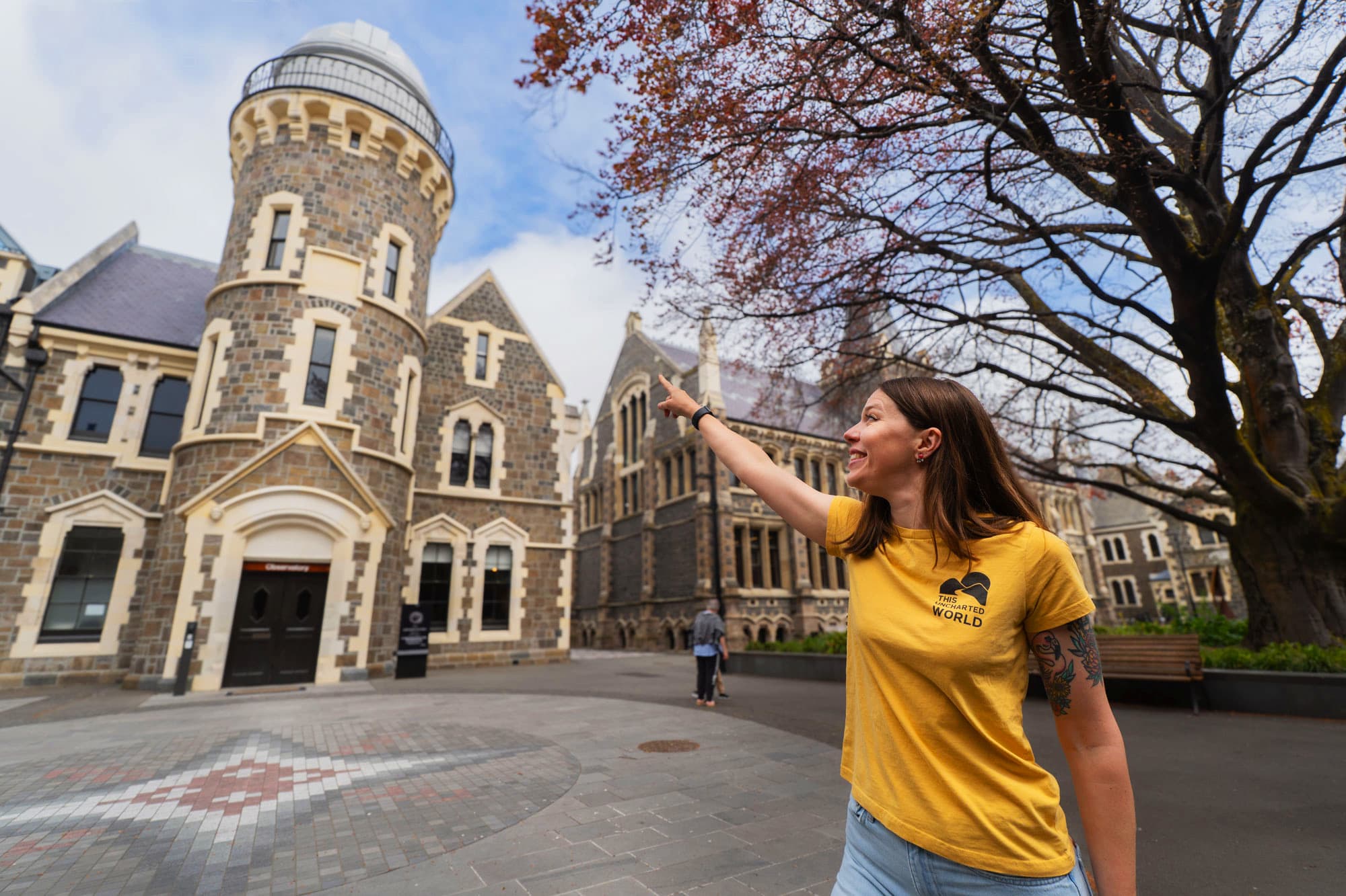 Jo, your local walking-tour guide, pointing to the Arts Centre Observatory in Christchurch
