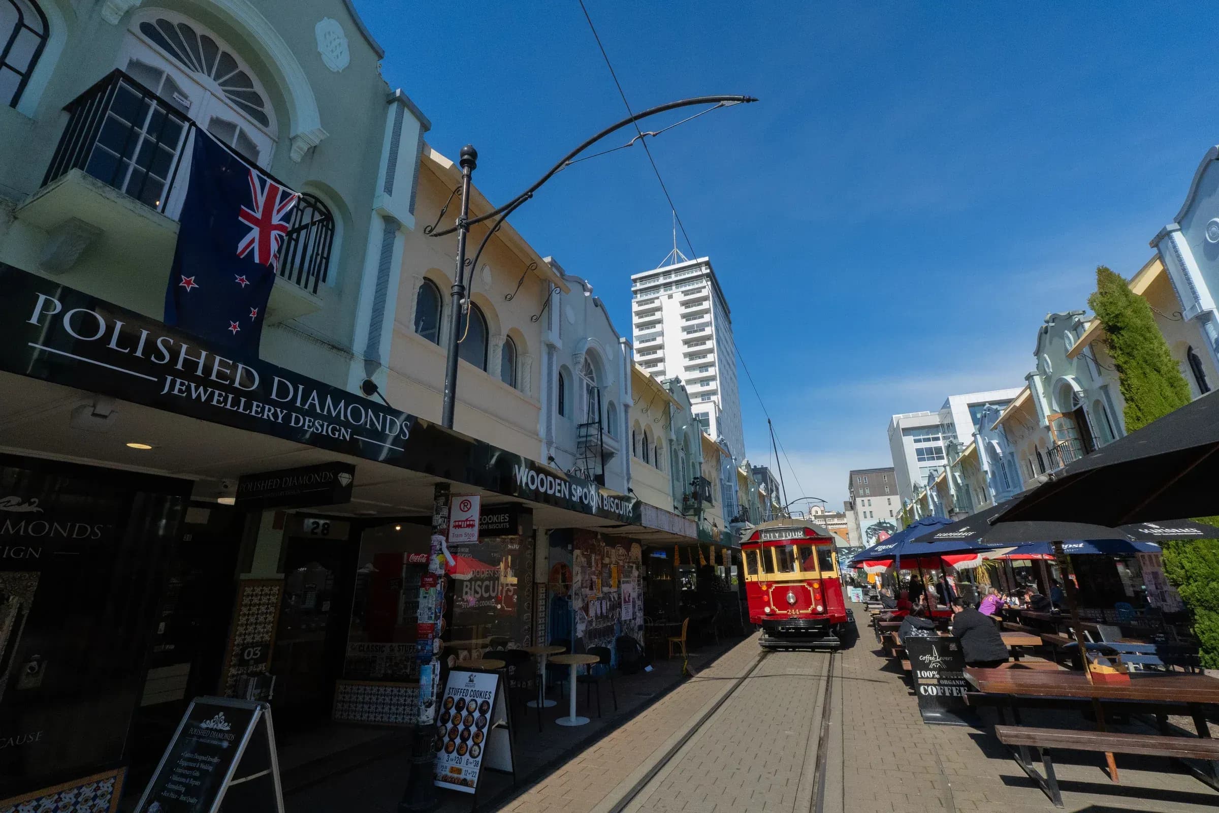 A heritage tram between the colourful façades of New Regent Street