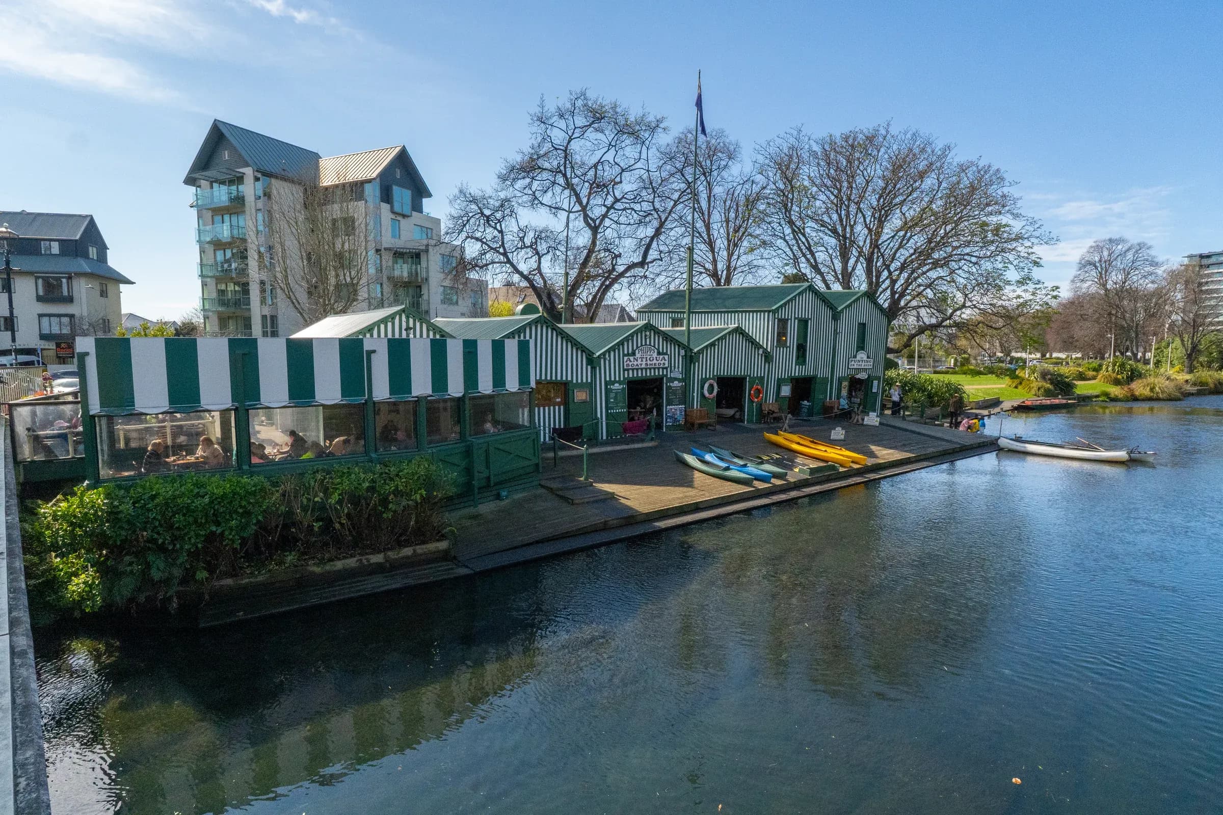 Colourful kayaks line the riverbank at Antigua Boatsheds.