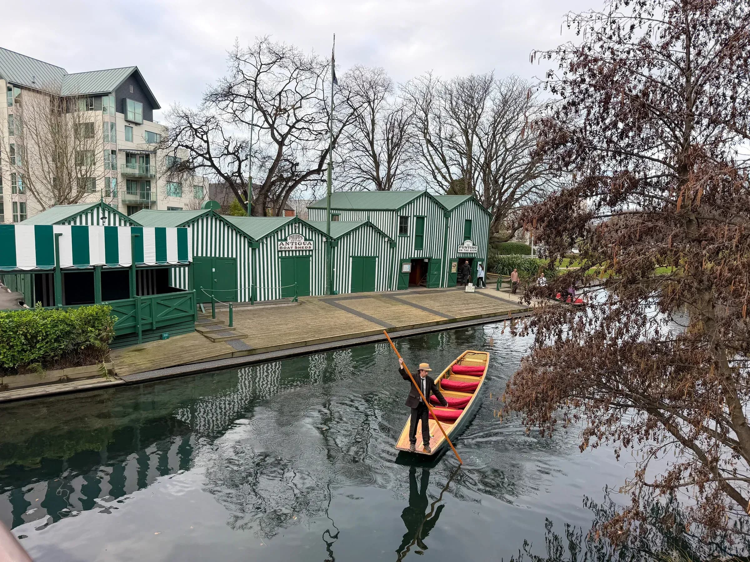 A punt passing the Antigua Boat Sheds on the Avon River